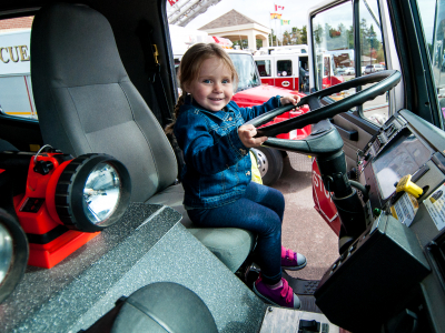Girl behind wheel of fire truck