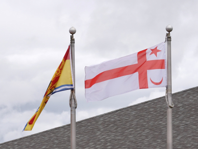 mi'kmaq grand council flag flies outside riverview town hall next to new brunswick provincial flag