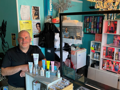 Salon owner standing next to counter