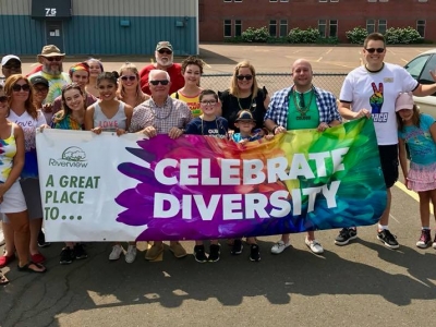 Mayor Andrew LeBlanc and members of Council hold up a colourful banner that reads "Celebrate Diversity" at a past Pride Parade